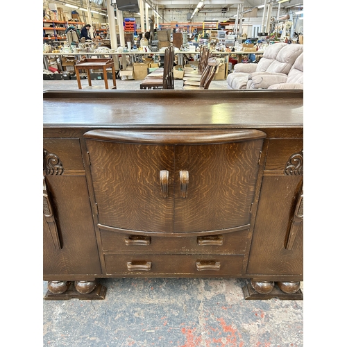 148 - An Art Deco style carved oak sideboard - approx. 94cm high x 137cm wide x 51cm deep