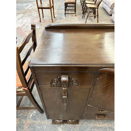 148 - An Art Deco style carved oak sideboard - approx. 94cm high x 137cm wide x 51cm deep