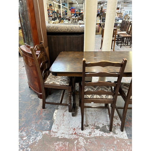 149 - An oak twin pedestal dining table and four chairs