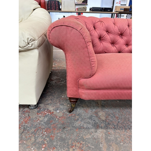 158 - A Victorian pink fabric button back upholstered sofa on turned mahogany supports and castors - appro... 