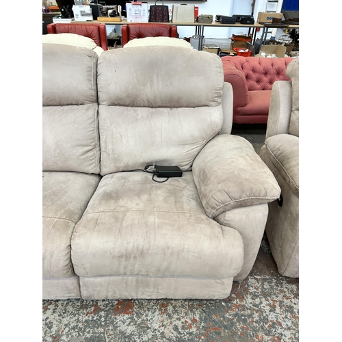 159 - A modern beige suede upholstered electric reclining two piece lounge suite comprising two seater sof... 