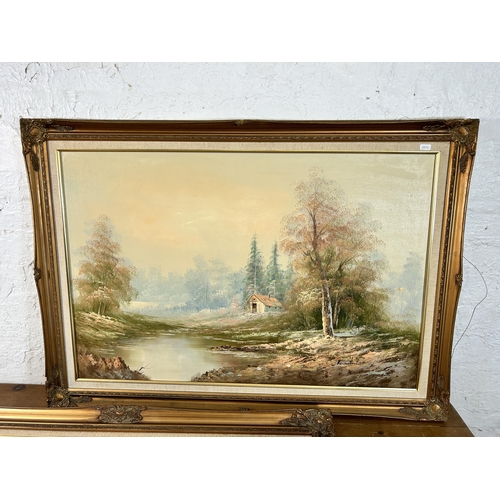 164 - Three framed oil paintings of lake and woodland scenes - largest approx. 75cm high x 110cm wide