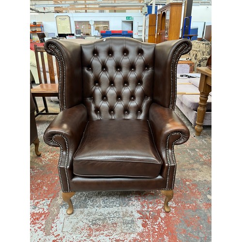 151 - A Buffalo brown leather Chesterfield wingback armchair on cabriole supports - approx. 103cm high x 9... 