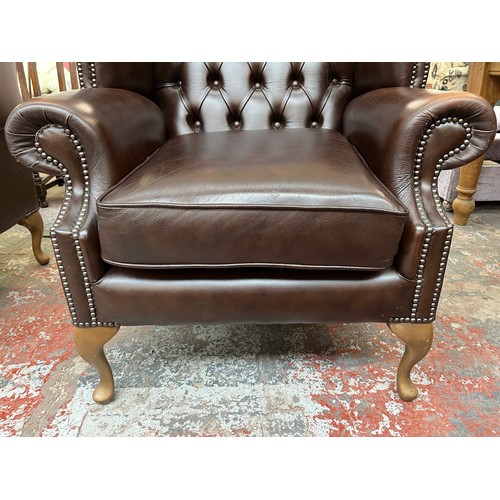 151 - A Buffalo brown leather Chesterfield wingback armchair on cabriole supports - approx. 103cm high x 9... 