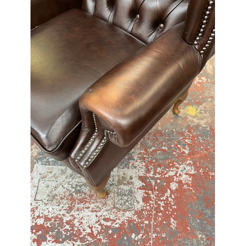 151 - A Buffalo brown leather Chesterfield wingback armchair on cabriole supports - approx. 103cm high x 9... 