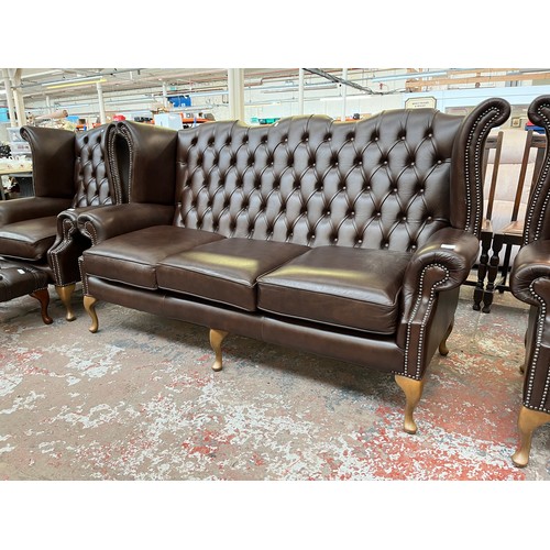 151A - A Buffalo brown leather Chesterfield wingback three seater sofa on cabriole supports - approx. 105cm... 