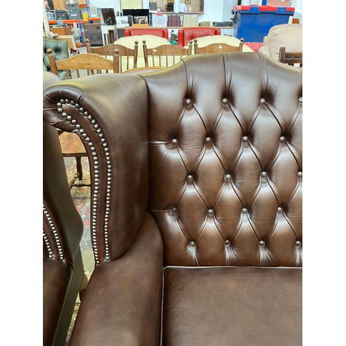 151A - A Buffalo brown leather Chesterfield wingback three seater sofa on cabriole supports - approx. 105cm... 