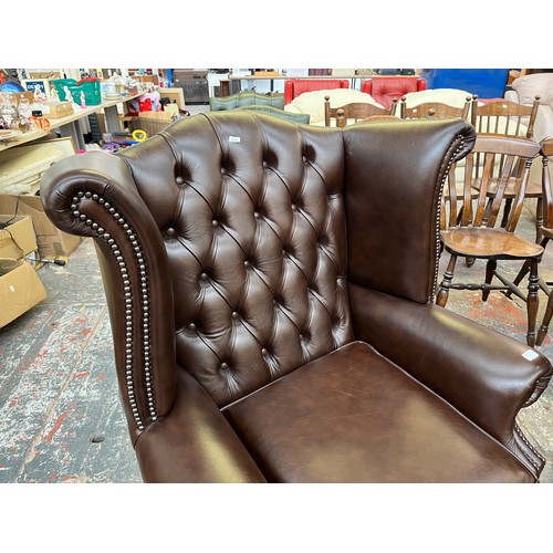 151B - A Buffalo brown leather Chesterfield wingback armchair on cabriole supports - approx. 103cm high x 9... 