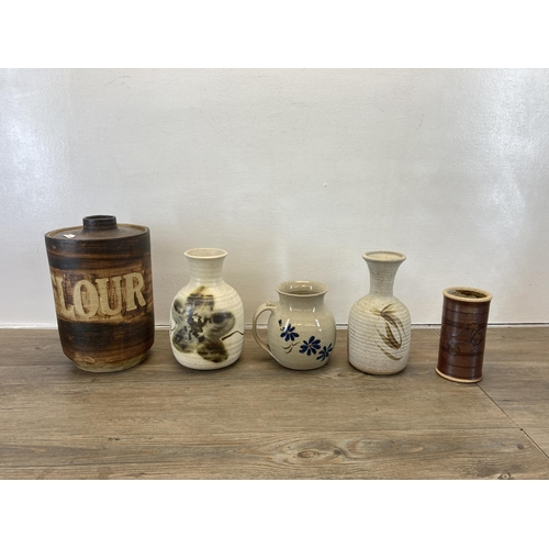 234 - A collection of studio pottery to include vases, jugs, flour cannister etc.