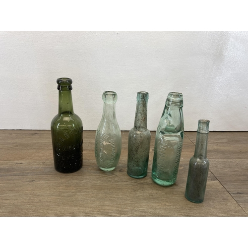 252 - A collection of antique glass bottles together with a ceramic pot lid