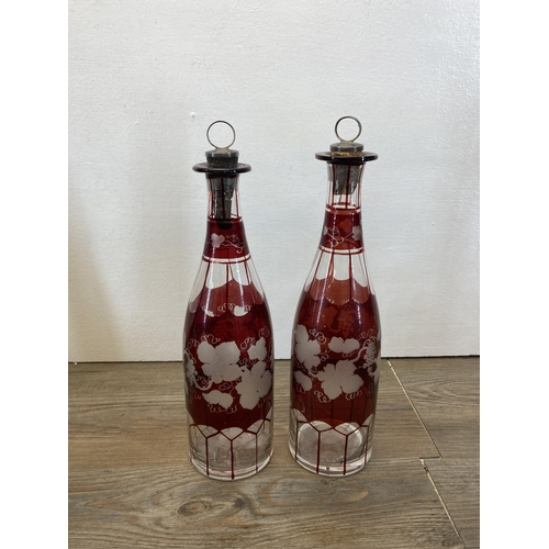 253 - Six glass decanters to include two Bohemian cranberry glass etc.