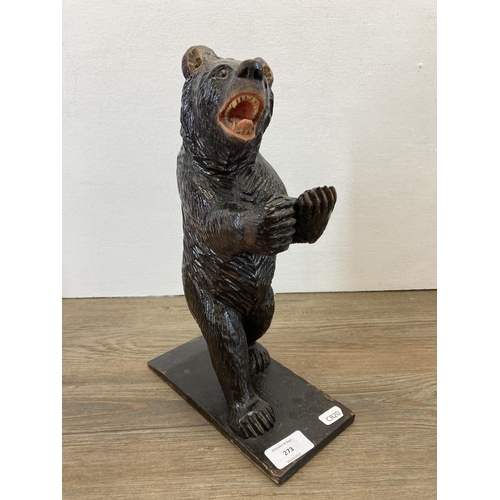 273 - A 19th century Black Forest carved bear in standing position with arms raised - approx. 33cm high