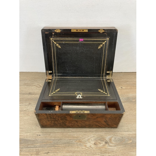 283 - A 19th century walnut writing slope with brass escutcheon and cartouche and black leather interior -... 