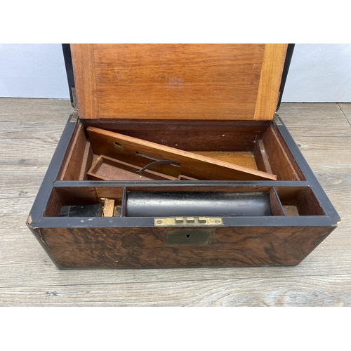 283 - A 19th century walnut writing slope with brass escutcheon and cartouche and black leather interior -... 