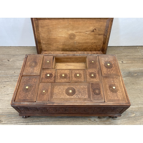 287 - A well carved Indian teak rectangular spice box with lion paw feet and bird and foliate design - app... 