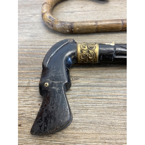 290 - Five 19th century and later walking sticks to include horn handled, carved ebony with 18ct gold plat... 