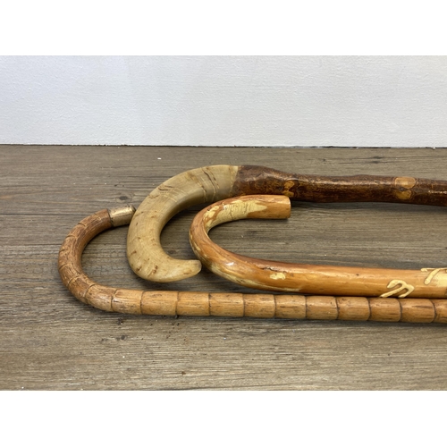 290 - Five 19th century and later walking sticks to include horn handled, carved ebony with 18ct gold plat... 