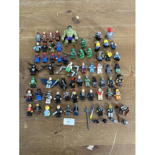 337 - A collection of film and superhero related Lego figurines to include Ironman, Batman, Indiana Jones,... 