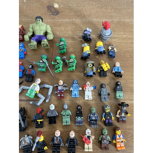 337 - A collection of film and superhero related Lego figurines to include Ironman, Batman, Indiana Jones,... 