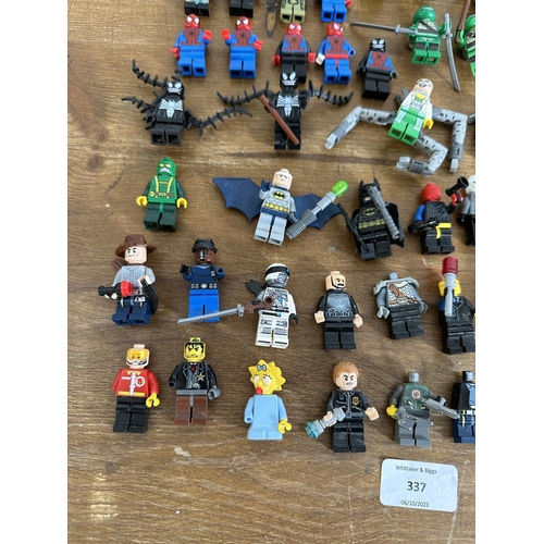 337 - A collection of film and superhero related Lego figurines to include Ironman, Batman, Indiana Jones,... 