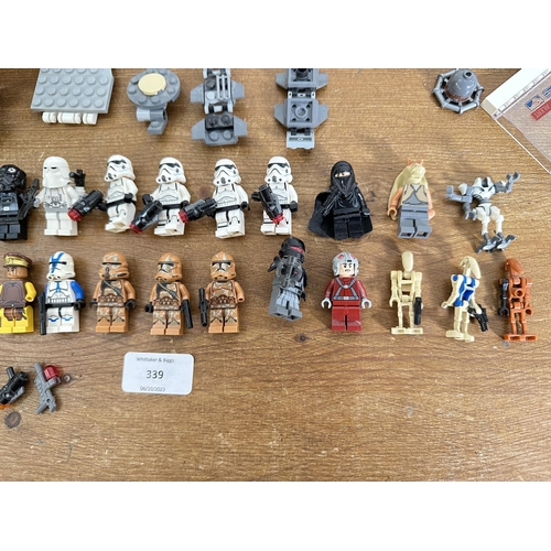 339 - A collection of Star Wars Lego to include Stormtrooper figurines, Darth Vader figurines, Tie Bomber,... 