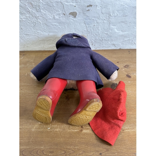 362 - A mid 20th century Paddington Bear soft toy with blue felt jacket, red felt hat and red plastic well... 