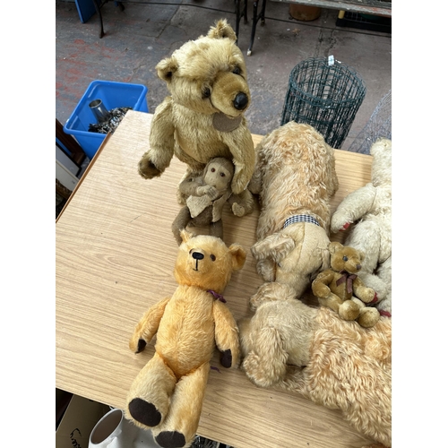 363 - A collection of soft toys to include mid 20th century articulated teddy bear, Aurora Teddy freestand... 