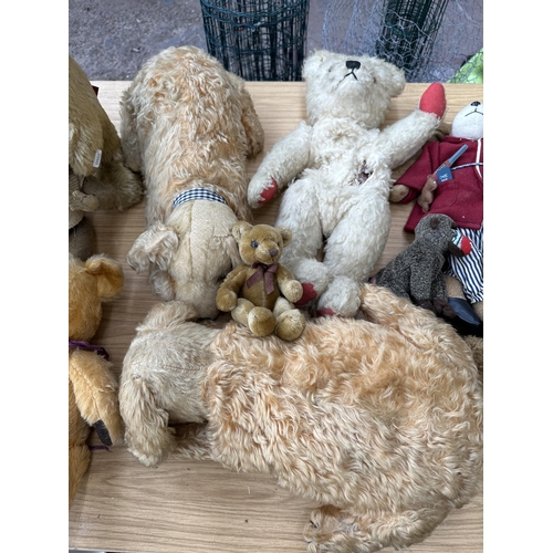 363 - A collection of soft toys to include mid 20th century articulated teddy bear, Aurora Teddy freestand... 