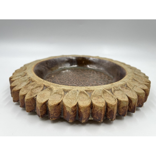 204 - A studio pottery sunflower circular dish - approx. 23cm diameter