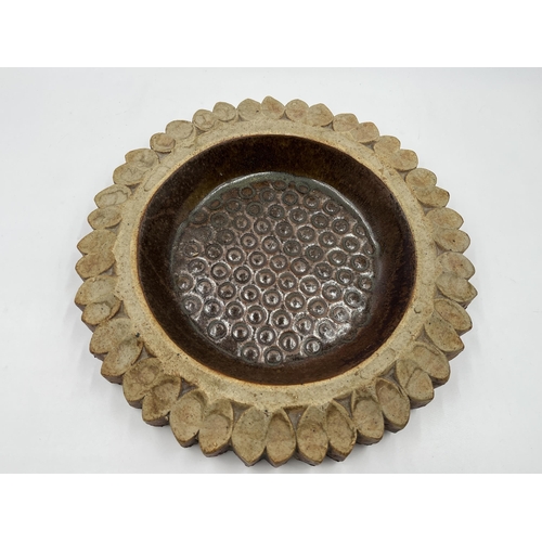 204 - A studio pottery sunflower circular dish - approx. 23cm diameter