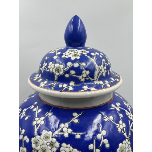 225D - A Chinese Prunus Blossom pattern hand painted porcelain vase and cover - approx. 37cm high