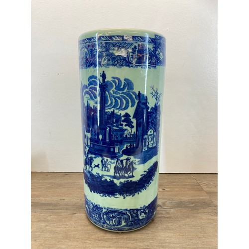 226 - A 19th century style blue and white ceramic stick stand containing a collection of walking sticks - ... 