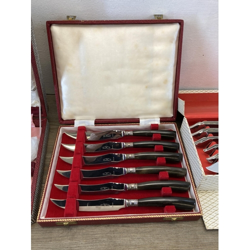 319 - Three cased cutlery sets