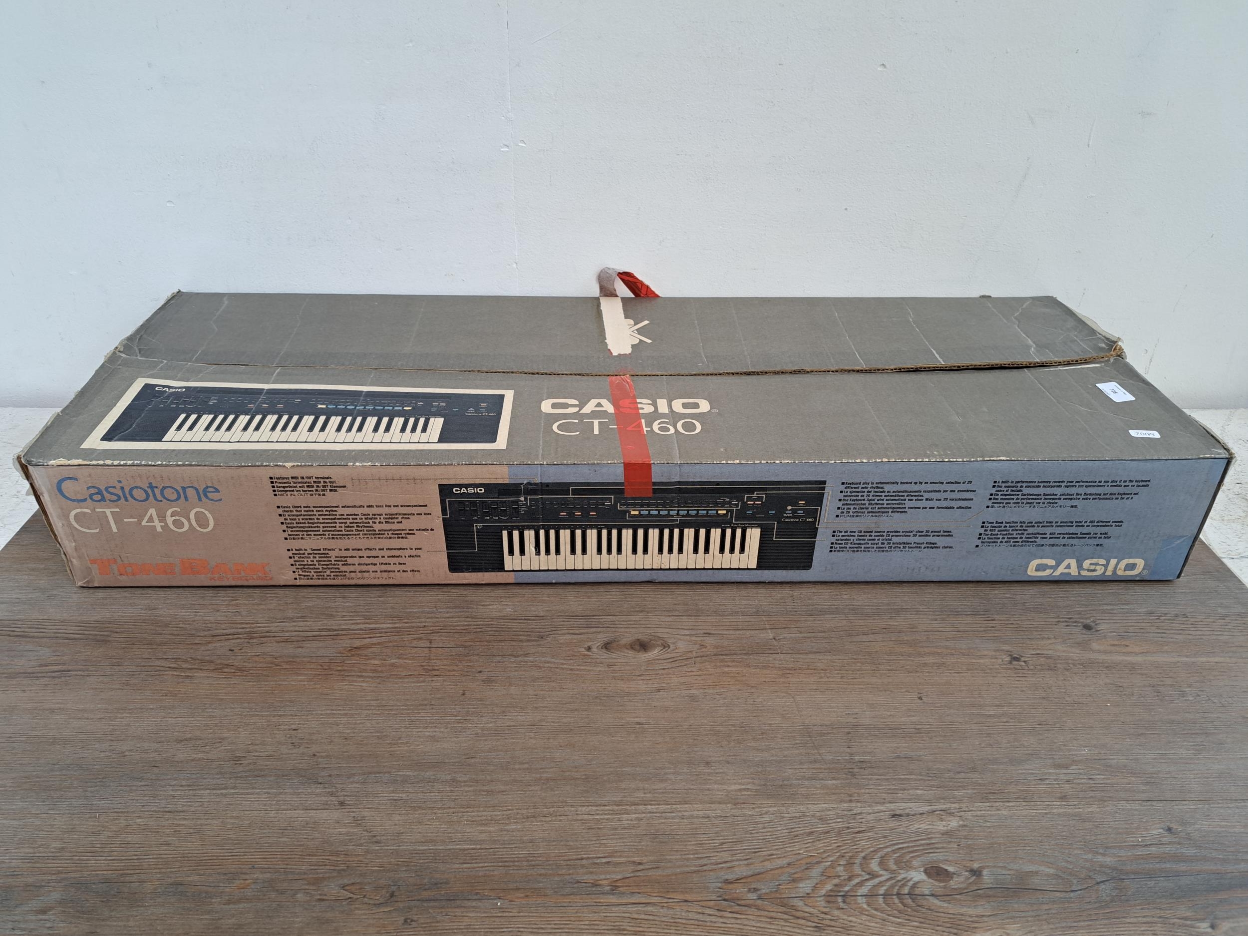 A boxed late 1980s Casio Casiotone CT 460 forty nine key electronic home keyboard with instruction m