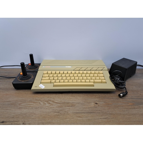 663 - An Atari 130XE 8-bit home computer with two joysticks and power adapter