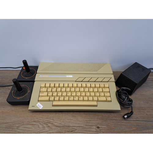 663 - An Atari 130XE 8-bit home computer with two joysticks and power adapter