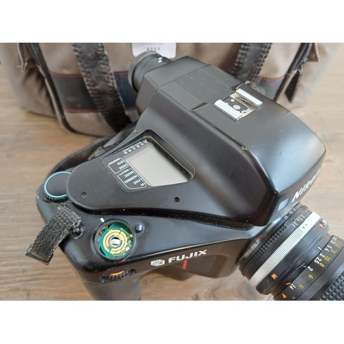 619 - A camera case containing mid 1990s Nikon Fujix E2s (3fps version of the E2) DSLR camera fitted with ... 