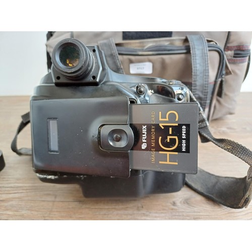 619 - A camera case containing mid 1990s Nikon Fujix E2s (3fps version of the E2) DSLR camera fitted with ... 