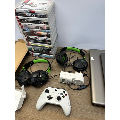 671 - A box of various tech items to include Turtle Beach gaming headsets, Sony PlayStation 3 games, Acer ... 