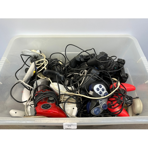 673 - A large collection of video game controllers