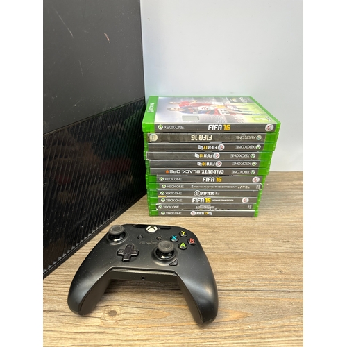 693 - Two Microsoft Xbox One consoles, controller and games to include FIFA 15, FIFA 16 and FIFA 17 etc.