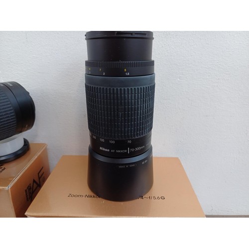 624 - Three camera lenses, one boxed Nikon Nikkor AF 28-100mm 1:3.5-5.6 G with instruction manual, one box... 