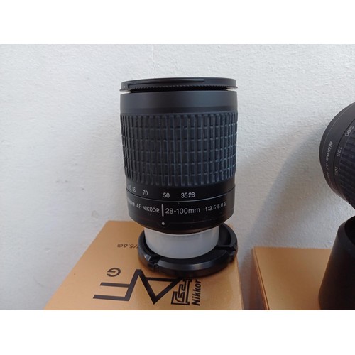 624 - Three camera lenses, one boxed Nikon Nikkor AF 28-100mm 1:3.5-5.6 G with instruction manual, one box... 