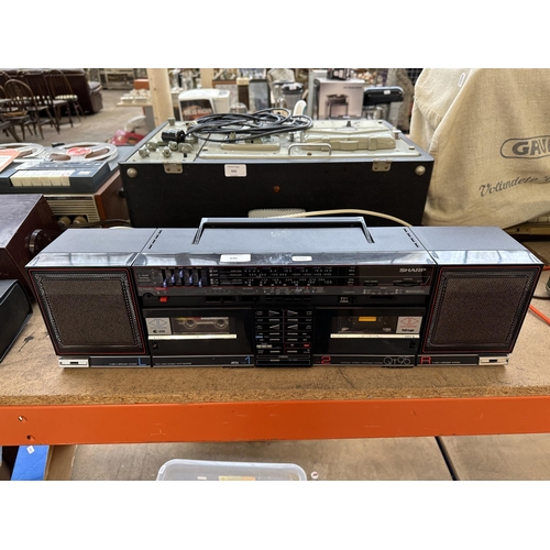 646 - A vintage Sharp QT95 portable stereo comprising four-band receiver, Dolby twin cassette deck and a p... 