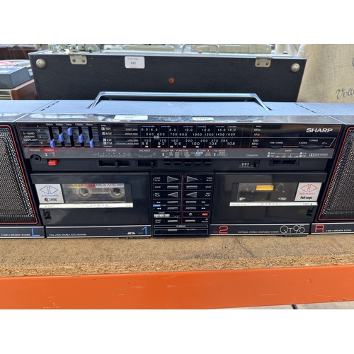 646 - A vintage Sharp QT95 portable stereo comprising four-band receiver, Dolby twin cassette deck and a p... 