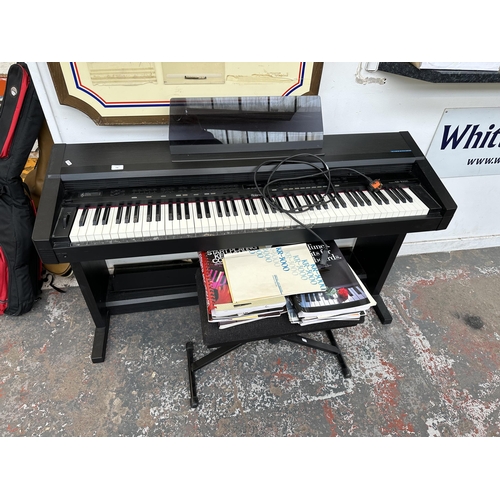 736 - A Roland KR-3000 eighty-eight key digital piano with stool, music books and instruction manual