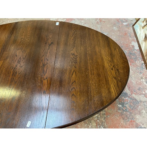 22 - A mid 20th century oak drop leaf gate leg oval dining table - approx. 75cm high x 90cm wide x 146cm ... 