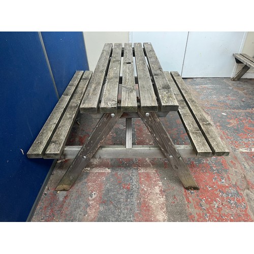 121 - A wooden picnic bench - approx. 75cm high x 127cm wide x 149cm long