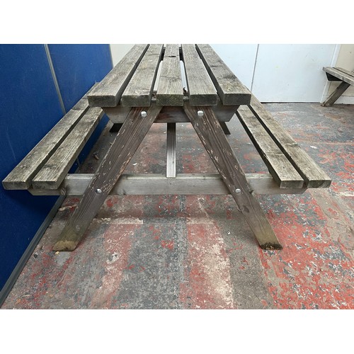 121 - A wooden picnic bench - approx. 75cm high x 127cm wide x 149cm long