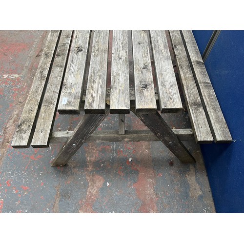 121 - A wooden picnic bench - approx. 75cm high x 127cm wide x 149cm long